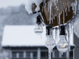 Roofing system in winter - icicles and market lights hang from roof