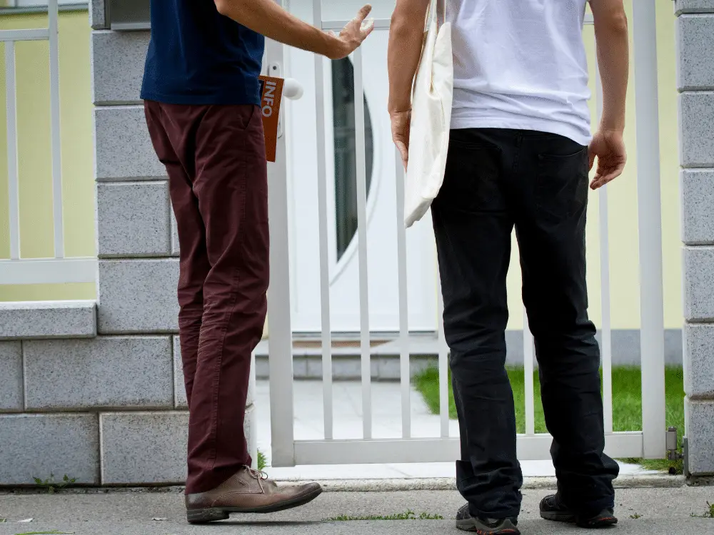 Insurance adjuster meeting roofer - Artisan Quality Roofing Storm chasers go door to door soliciting jobs