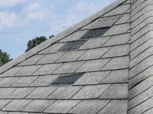 Roof with missing shingles from wind damage needing Roof repair Raleigh NC