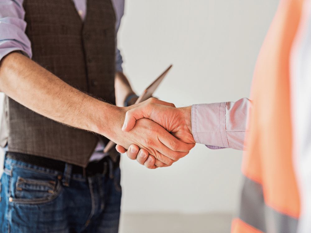 Contractor and homeowner shake hands in agreement