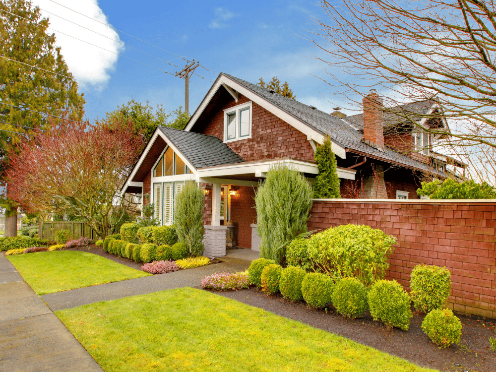 Home with spring garden - brick siding - beautiful asphalt shingle roof
