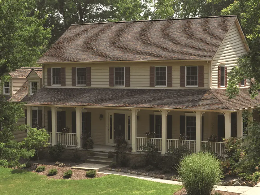 Home with tan siding and an Owens Corning roof