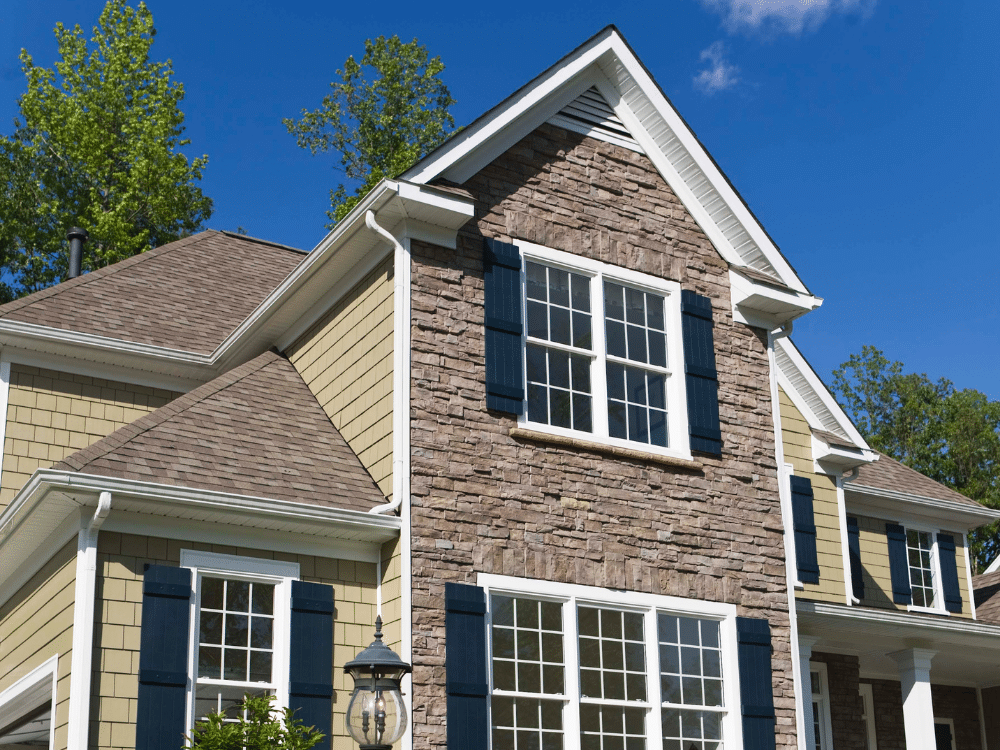 Cream green siding - stone facade - brown roof