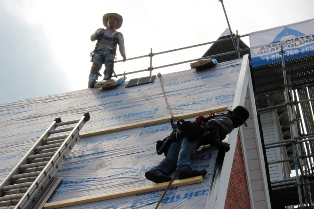 Close-up-roof-crew-on-top-steep-roof