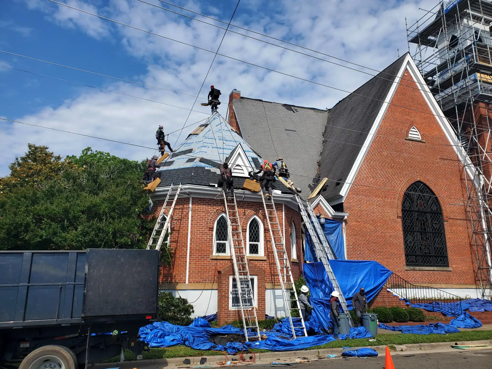 Roof crew shingles gazebo shaped church roof