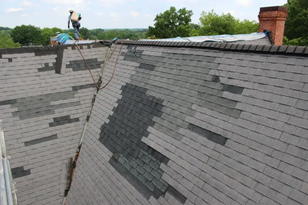 Technician-on-roof-peak-getting-shingle-bundle-2 - Artisan Quality Roofing Technician-on-roof-peak-getting-shingle-bundle-2