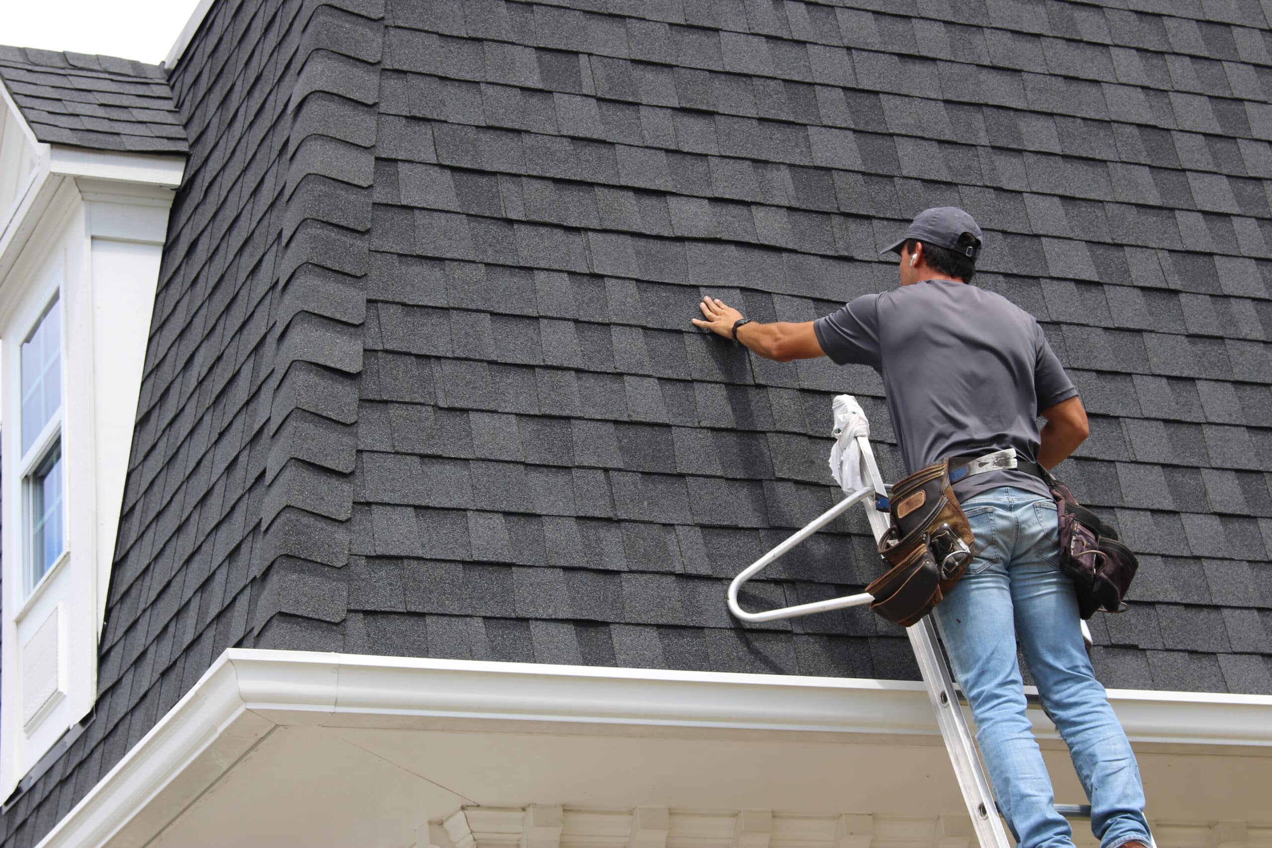 Roof Repair Technician - Artisan Quality Roofing Roofing technician repairing moire black shingles