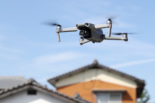 Drone flying near a private house - Artisan Quality Roofing Drone vs Ladder roof inspection?